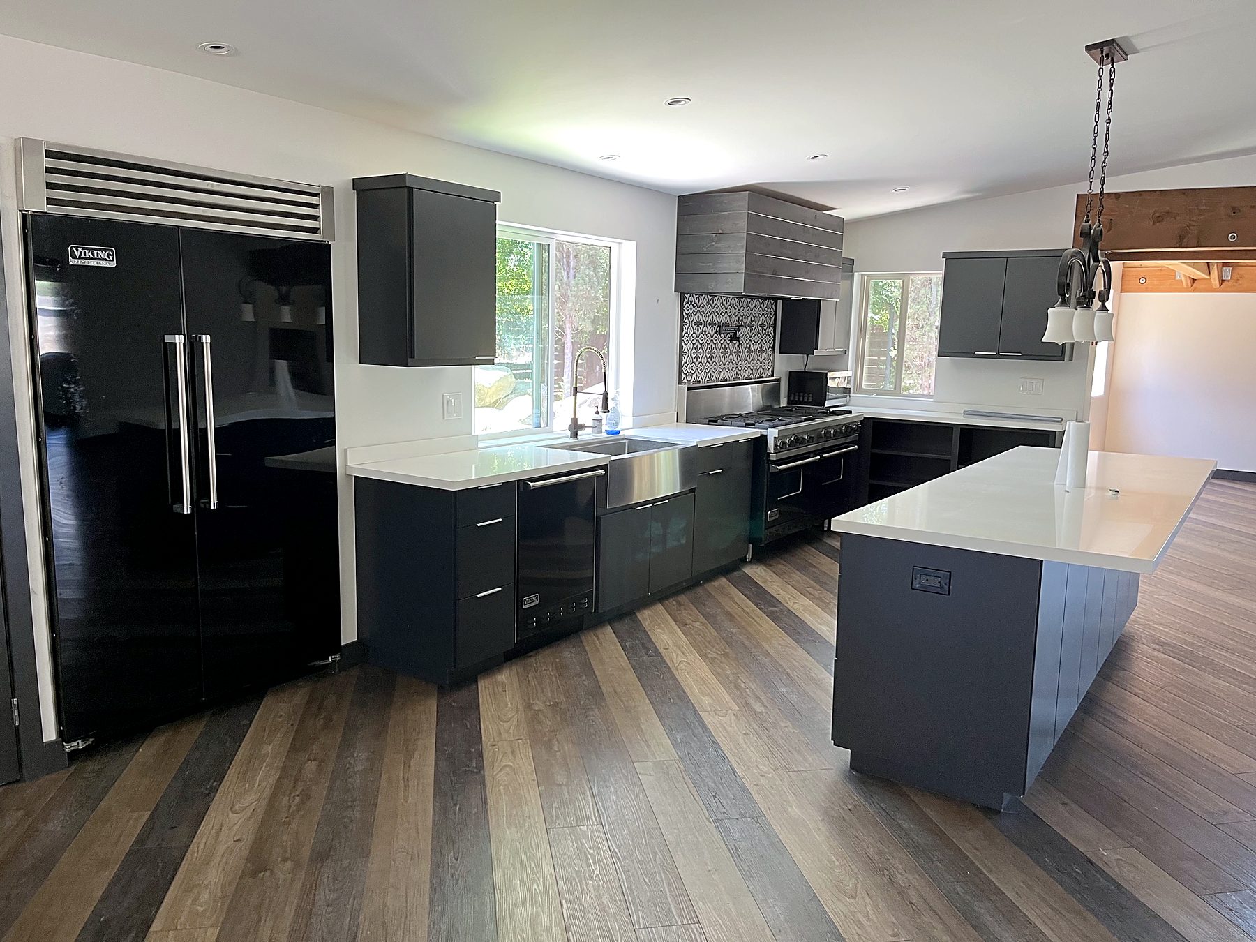 Wide plank wood flooring in a finished kitchen by Edgewood Remodel and Construction